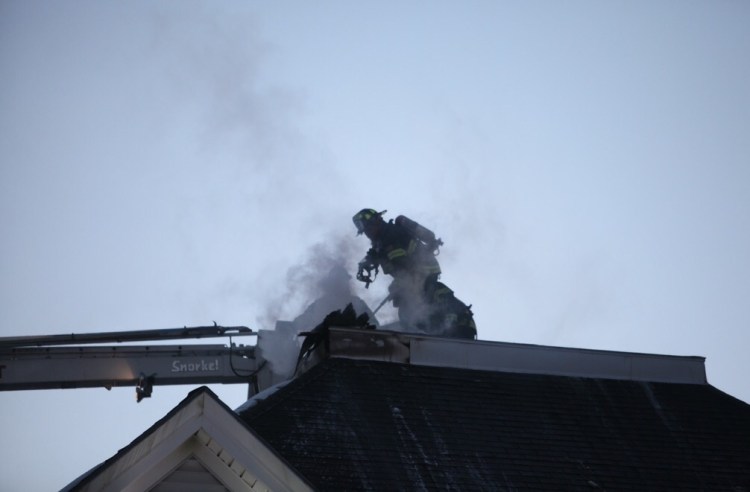 Firefighters battle a blaze at 434 Forest Ave. in Portland on Sunday. 
Jill Brady/Staff Photographer