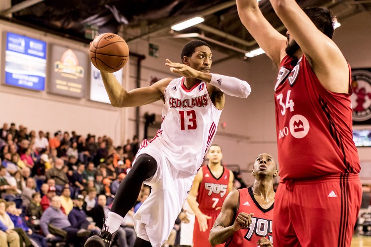 Maine Red Claws forward Malcolm Miller looks across the court for an open teammate before running into the brick wall of 7-foot-4 Sim Bhullar, the Rapters 905's center, under the basket. Miller's pass was successful and set up  guard Marcus Thornton for a three-pointer.