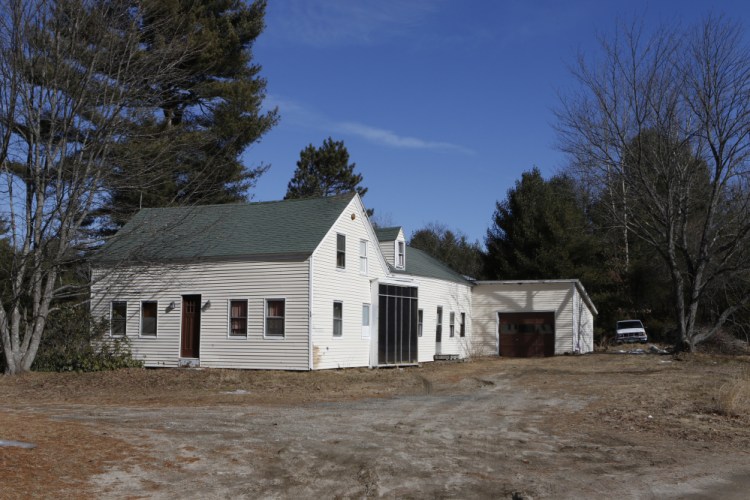 Shawn Farnell, 43, buried his mother behind this aging house in East Baldwin.