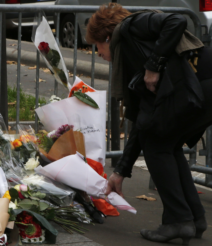 A woman lays flowers outside the Bataclan theater in Paris after the Islamic State’s deadly attacks. The rise of ISIS represents a struggle for power.