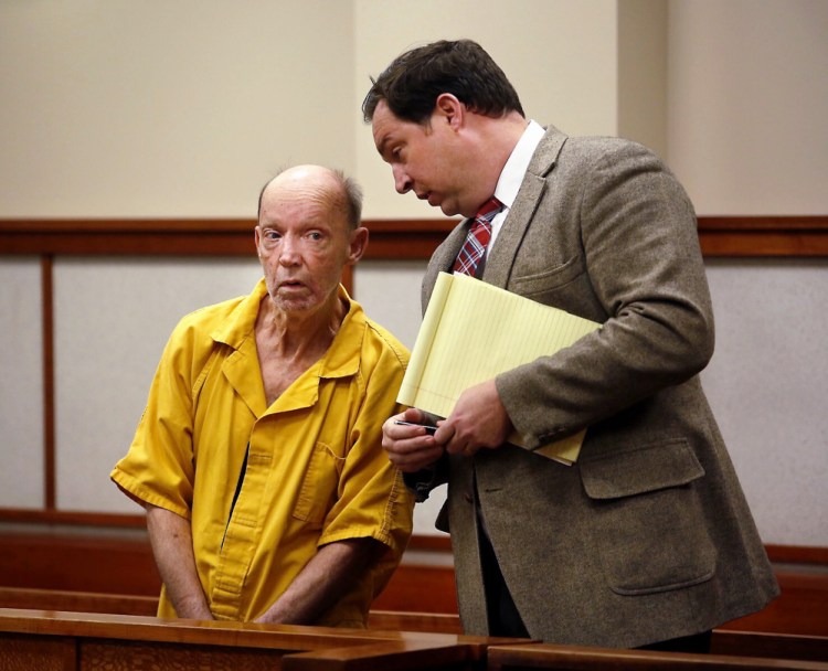 David Pinkham, 67, the Bridgton man accused of shooting and killing another man outside his Sebago home on Saturday, listens to attorney Andrew Wright at his initial court appearance Monday.