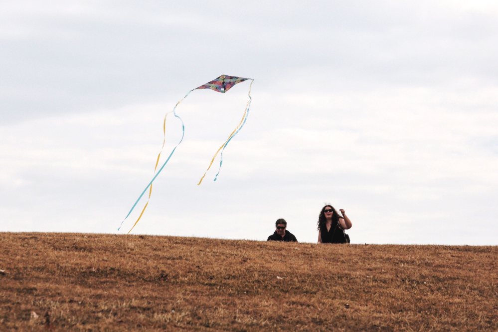 Hannah Surabian, right, and her mother, Brenda Surabian, fly a kite while taking advantage of the warm weather at Fort Williams Park in Cape Elizabeth on Wednesday. 