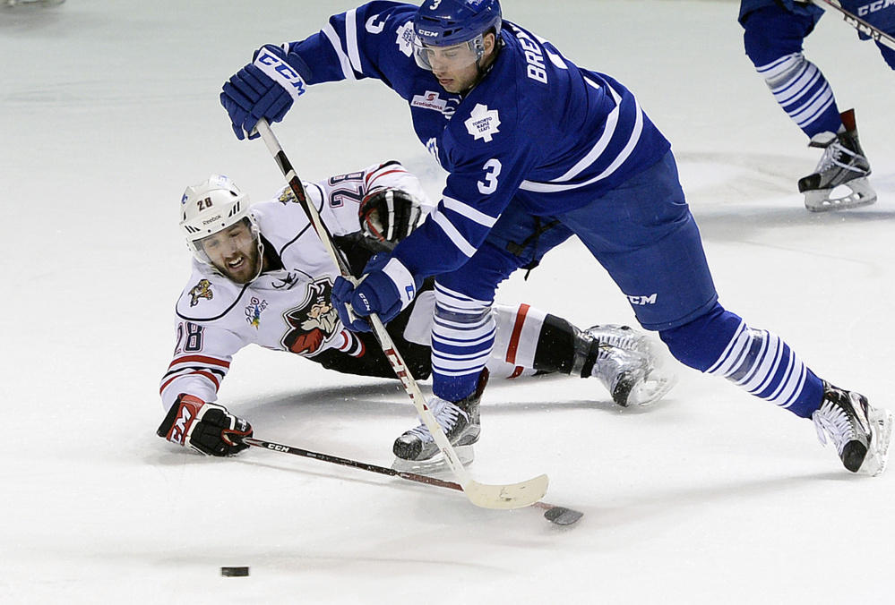 Portland’s Wade Megan dives to try to break up a play by T.J. Brennan of Toronto on Friday. 
Shawn Patrick Ouellette/Staff Photographer