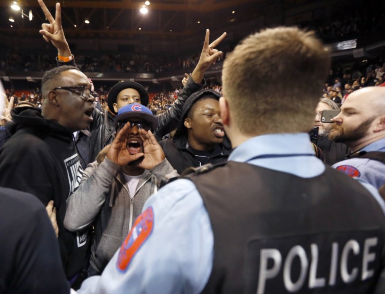 Protesters shout at Trump supporters after it was announced that the candidate’s rally was canceled because of security concerns on the campus of the University of Illinois-Chicago on Friday.