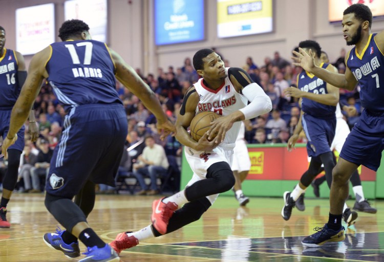 Maine's Corey Walden drives through the Iowa Energy defense Thursday. Iowa's Ramon Harris, left and Andrew Harrison, right, are in on defense. Shawn Patrick Ouellette/Staff Photographer