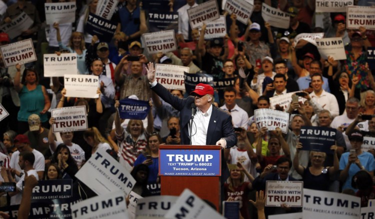 Republican presidential candidate Donald Trump waves to the crowd as he speaks during a campaign rally Saturday in Tucson, Ariz.