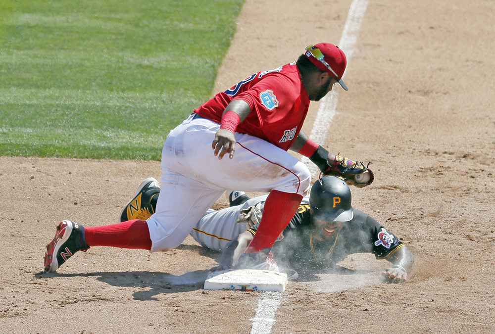 Pittsburgh Pirates' Jason Rogers gets back to third before a tag on a pickoff attempt by Pablo in an interleague spring training game on March 14 in  Fort Myers , Fla. The Associated Press