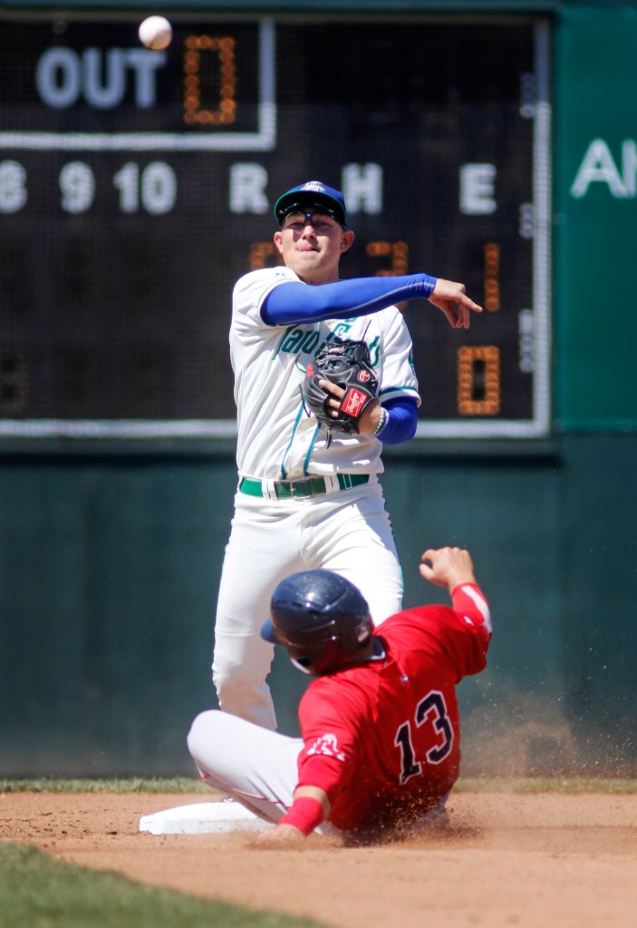 Portland's Ali Solis slides in a little late in an attempt to steal second base as Hartford's Pat Valaika throws to first for a double play in the third inning.