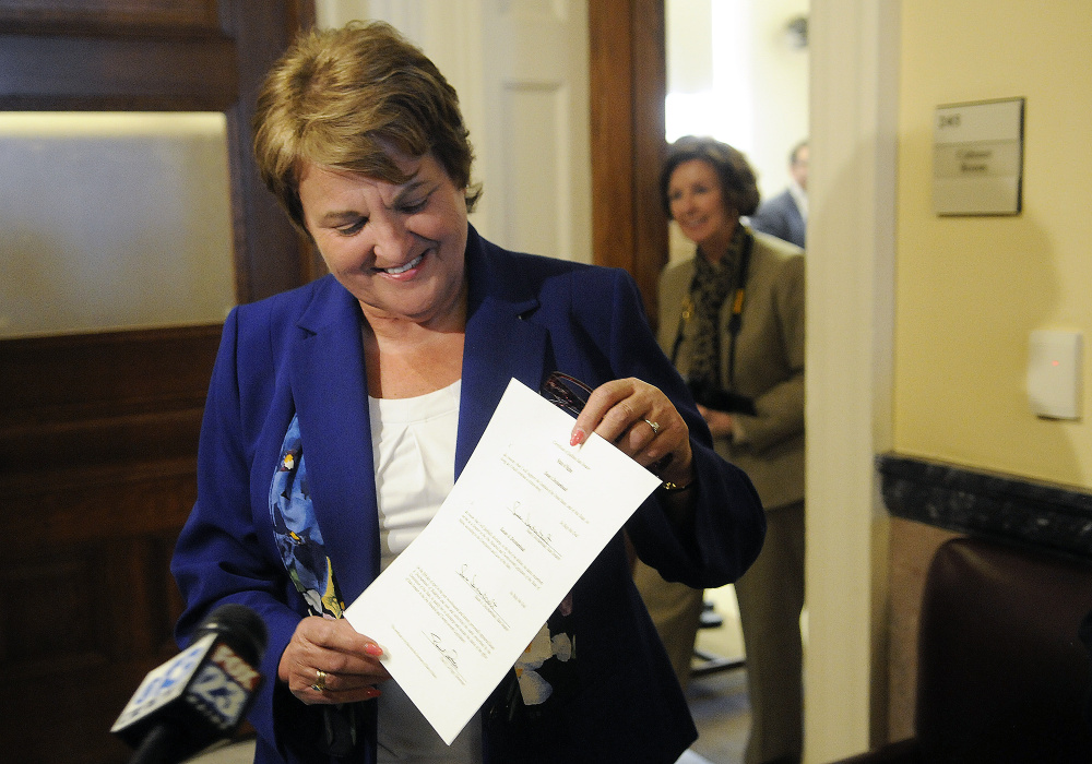 Susan Deschambault holds her certificate as a state senator after being sworn into office Tuesday afternoon in the governor's Cabinet room.