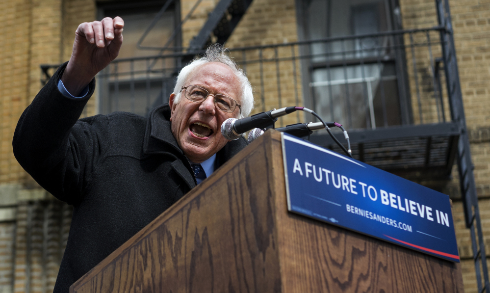 With his childhood home in the background, Democratic presidential candidate Sen. Bernie Sanders, I-Vt. speaks in Brooklyn on Friday.