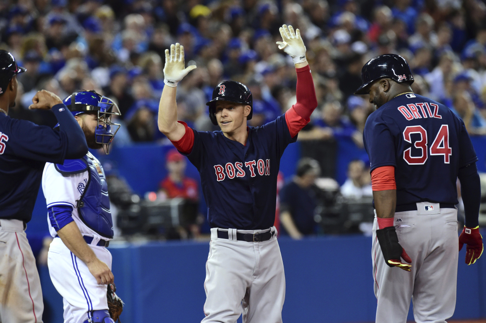 Boston's Brock Holt celebrates after hitting a grand slam against the Toronto Blue Jays in the sixth inning Friday night in Toronto.