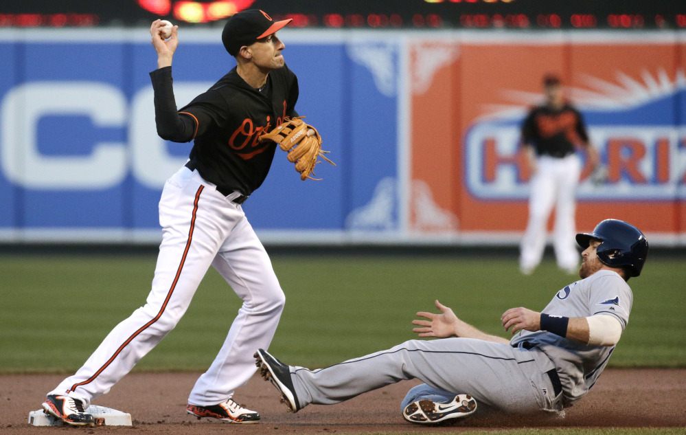 Baltimore's Ryan Flaherty, left, who has taken on a utility role as both an infielder and outfielder, is prized for his glove but also noted for his postseason productivity at the plate.