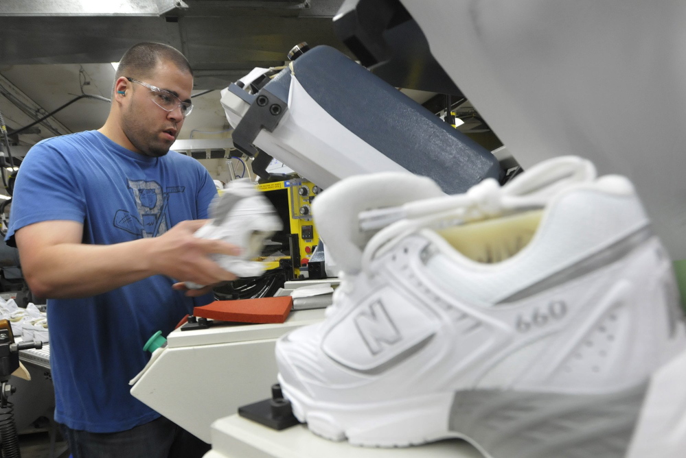 Justin Waring lays soles on shoes at New Balance in Norridgewock in 2011. The Department of Defense has delayed requiring service members to buy American-made athletic shoes, putting the future of the company and hundreds of Maine families in jeopardy.