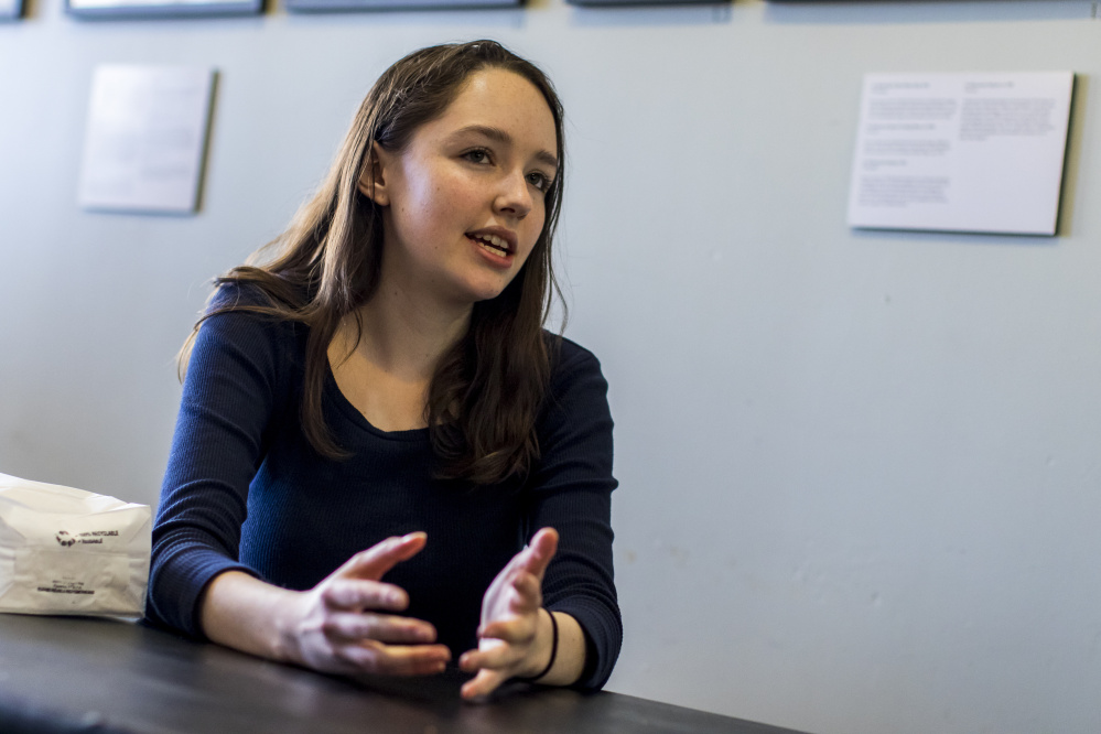 Oona Mackinnon-Hoban, a junior at Portland High School, discusses politics at the Public Market during her lunch period Wednesday.