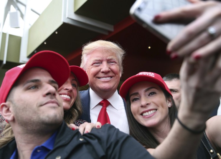 Supporters take a photograph with Republican presidential candidate Donald Trump at a campaign rally Sunday in the Staten Island borough of New York.