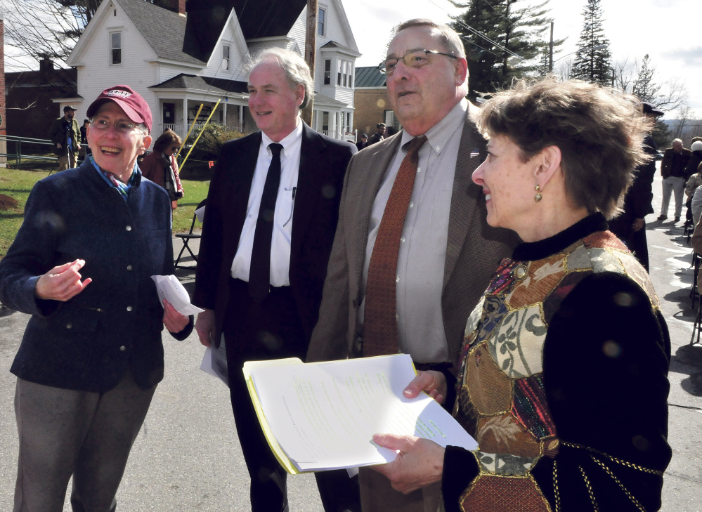 Former University of Maine at Farmington President Theodora Kalikow, left, looks back at the Theodore Kalikow Education Center building, which was dedicated on Tuesday. Beside Kalikow, before Tuesday's event, are university Chancellor James Page, Gov. Paul LePage and UMF President Kathryn Foster.