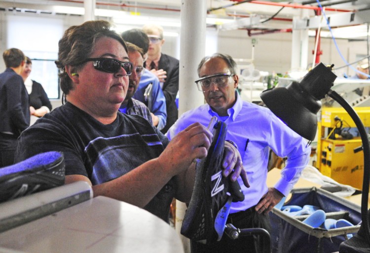 U.S. Rep. Bruce Poliquin watches the construction of an athletic shoe during a tour of the New Balance factory in Norridgewock. A change in federal law could require the Defense Department to buy U.S.-made shoes for service members.