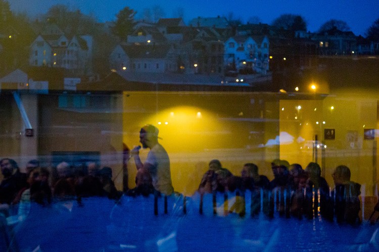 Daniel Meyerowitz of Portland, a recovering opiate addict, is reflected in a window at Ocean Gateway as he speaks to the audience at the Portland Community Opiate Forum.