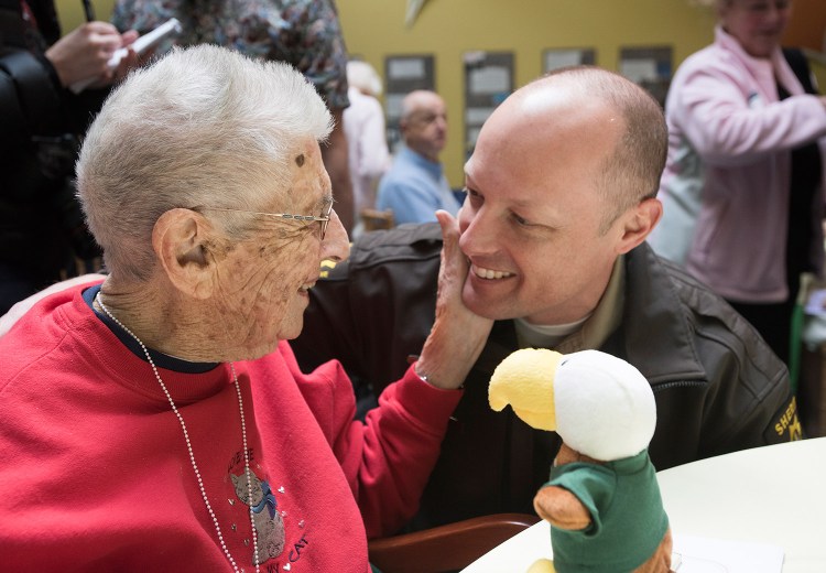 Clara Swan greets a nephew, Will Sheehan, at Husson University on Thursday. 