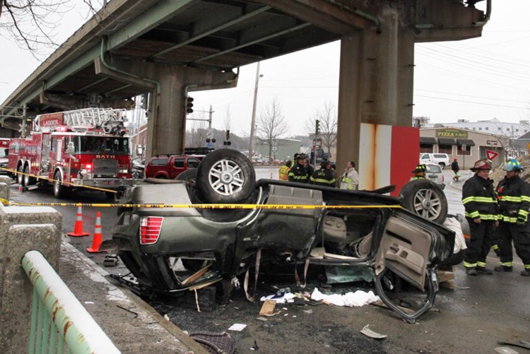A Mercury Mountaineer rests on its roof on Leeman Highway in Bath after plunging off the Route 1 overpass on Monday afternoon.