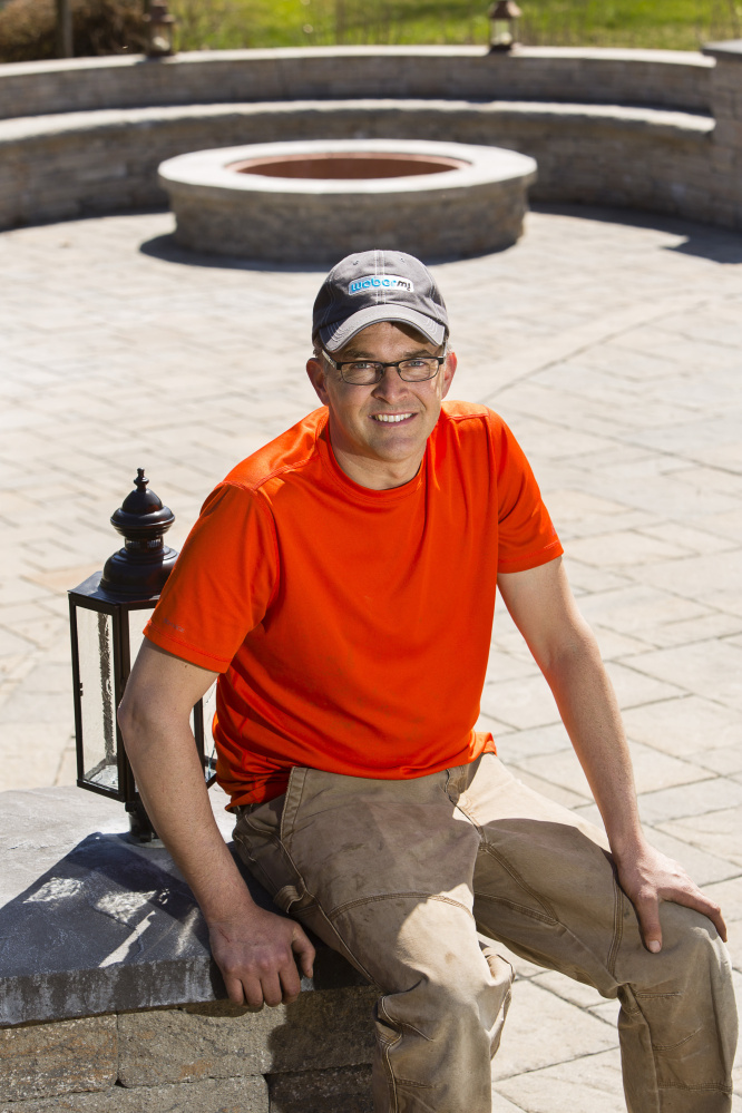 Ken Fengler near a patio and fire pit he built in Scarborough.