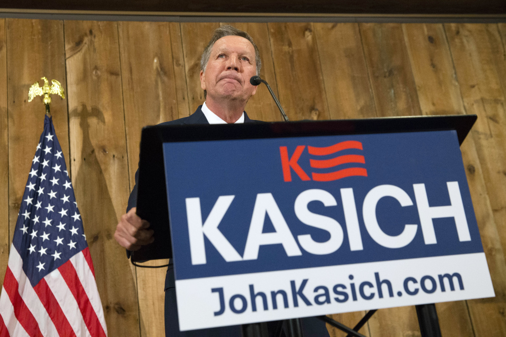 Ohio Gov. John Kasich pauses as he speaks during a news conference at The Franklin Park Conservatory & Botanical Gardens on Wednesday in Columbus. Ohio. Kasich announced the end of his underdog White House bid.