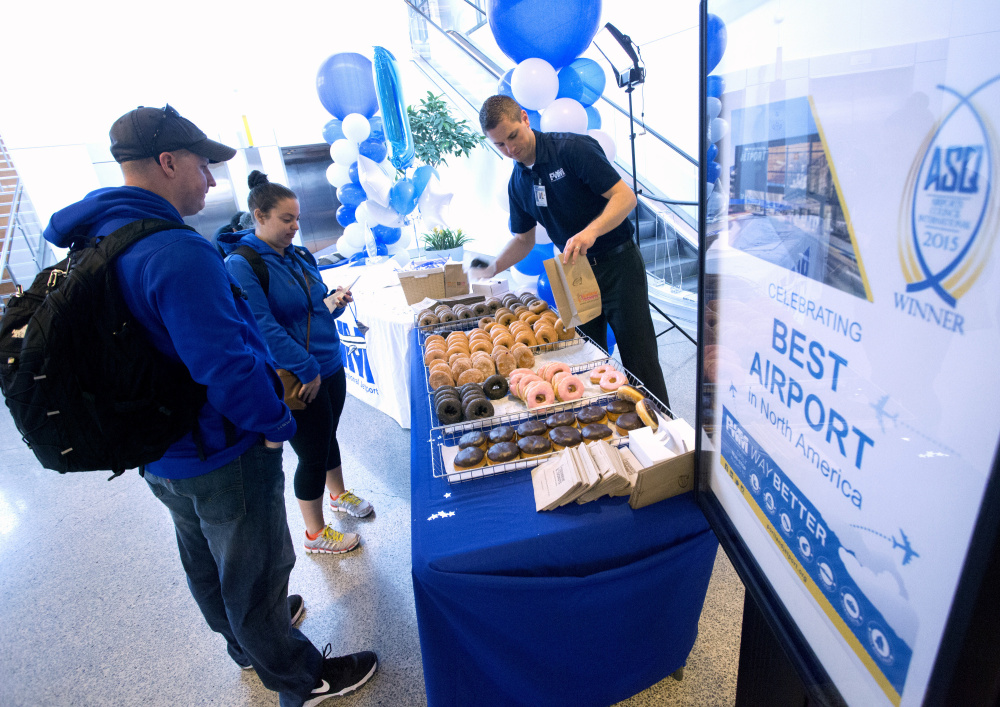 On Friday, Portland International Jetport celebrated its recent recognition by the Airport Council International's Airport Service Quality program as the best airport in North America for its size. Jetport personnel handed out doughnuts and cake, as well as free baggage tags, to passengers  in recognition of their customer service achievement. The honor was based on the results of monthly customer satisfaction surveys. Derek Davis/Staff Photographer