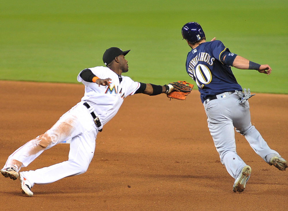 Miami shortstop Adeiny Hechavrria tags out Milwaukee's Kirk Niewenhuis during the fifth inning of a 4-1 win by the Marlins Monday at Miami.