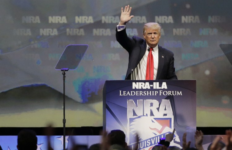 Republican presidential candidate Donald Trump, at the National Rifle Association convention in Louisville, Ky., on Friday, fails to detail his position on guns and instead vilifies Hillary Clinton.