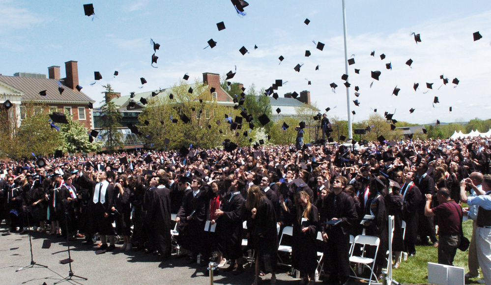 Colby College graduates throw their mortarboards in the air following commencement in Waterville on Sunday.