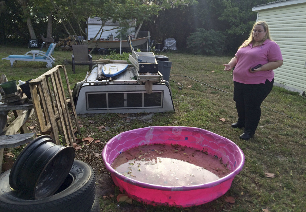 Rachael Heid, a dengue victim in 2013, talks to a reporter, at her home in Rio, Fla.