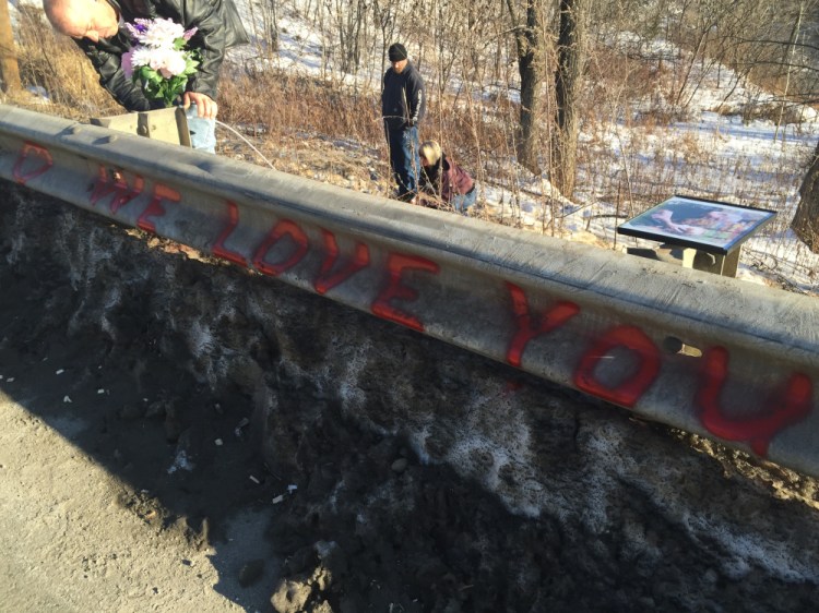 Ricky Gaboury secures flowers to a memorial where his daughter Taylor Gaboury was struck and killed by a car Jan. 1 in Farmington as she walked home. Five pedestrians and one cyclist have died so far this year in road accidents in Maine.