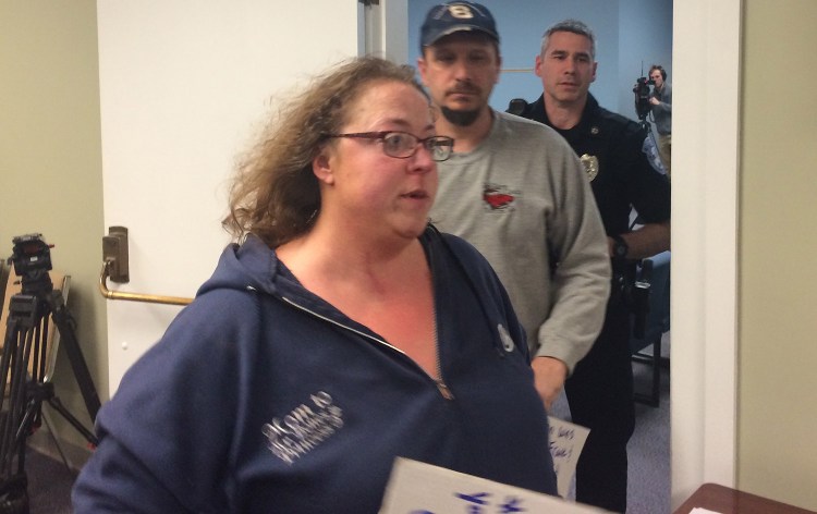 Melissa Bourgeois-Lang leaves Monday night's SAD 6 board meeting, followed by her husband, after shouting at the superintendent, telling him to resign.
