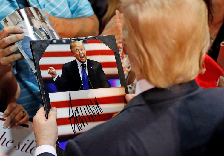 Republican presidential candidate Donald Trump signs autographs at the end of a campaign rally in Eugene, Ore., on Friday. There are unhappy delegates at every party convention, but the captive audience of Trump skeptics bound for Cleveland is unique. Reuters