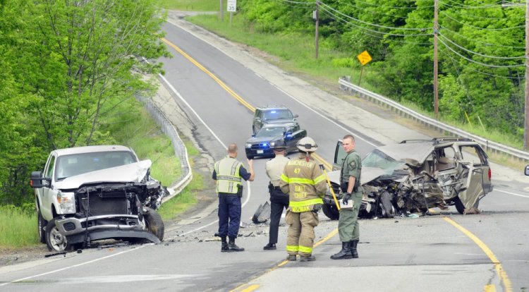 A woman was killed Tuesday when her SUV crossed the center line and hit a pickup truck in Manchester.