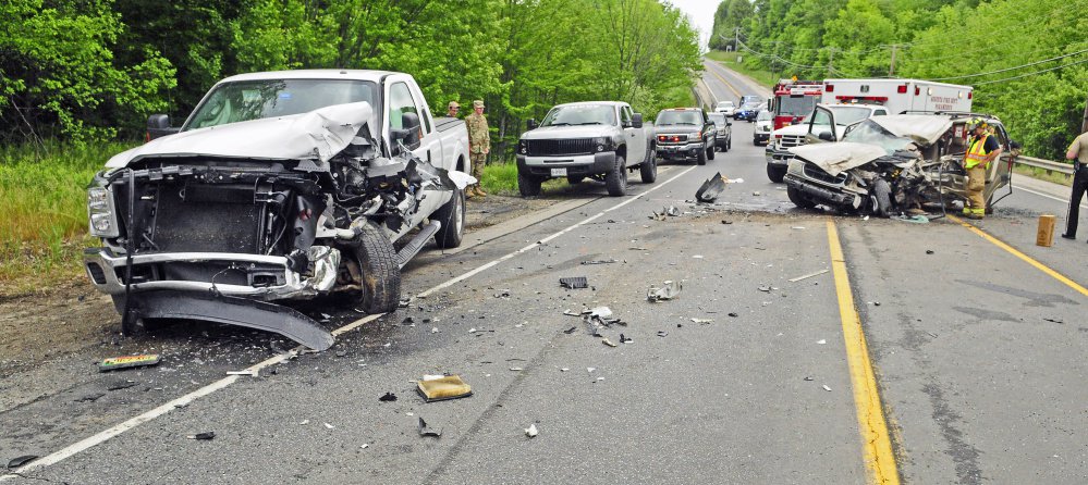 Officials work at the scene of a fatal two-vehicle crash on Tuesday on Western Avenue, also called U.S. Route 202, in Manchester near the Augusta line. 