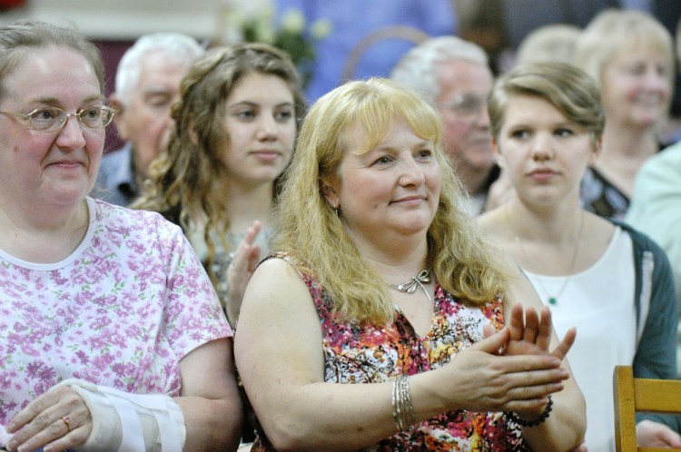 Katherine Jordan of Durham, a niece of Nancy Randall Clark, applauds a story told about her aunt at the celebration honoring Clark's life.