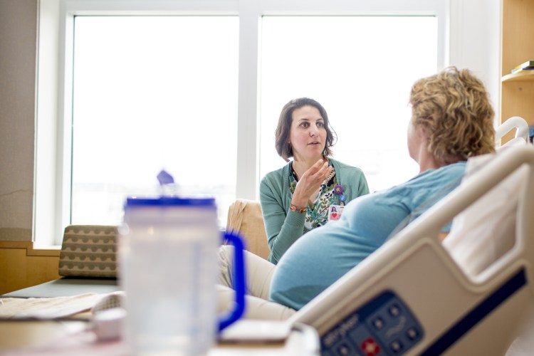 Kara Kaikini, childbirth education and lactation manager at Maine Medical Center, consults with mother-to-be Roberta Green of Topsham.