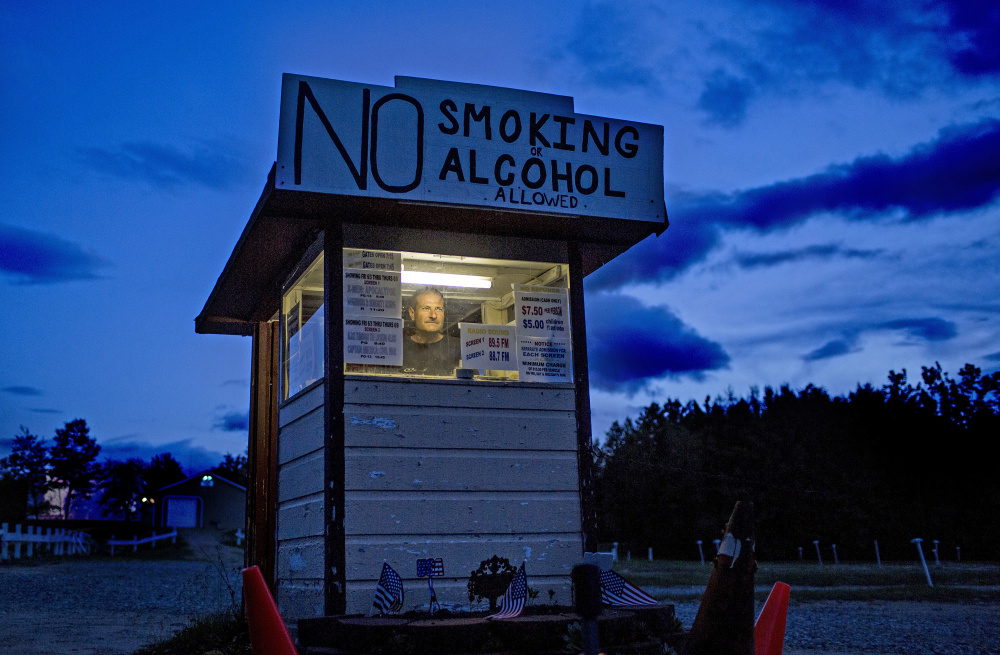 John Tevanian, owner of the Bridgton Twin Drive-In Theatre, waits for patrons at the front gate last Wednesday. He's not sure if he'll lose customers now that the state has informed him it's illegal for drive-in patrons to smoke in their cars.