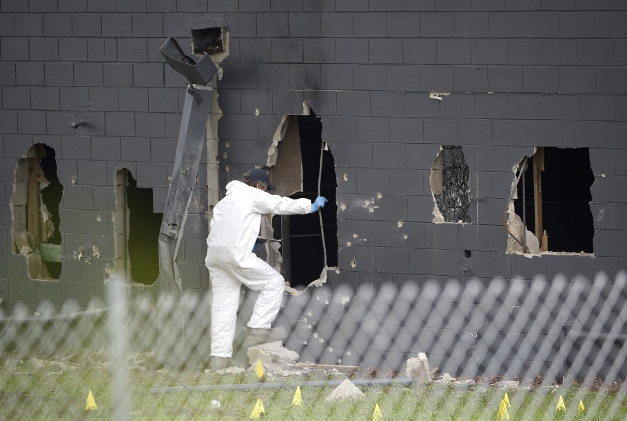 asdf;lkjk .... Law enforcement officials investigate the rear of Pulse Orlando after a shooting involving multiple fatalities at the nightclub in Orlando, Fla., Sunday, June 12, 2016.(AP Photo/Phelan M. Ebenhack)