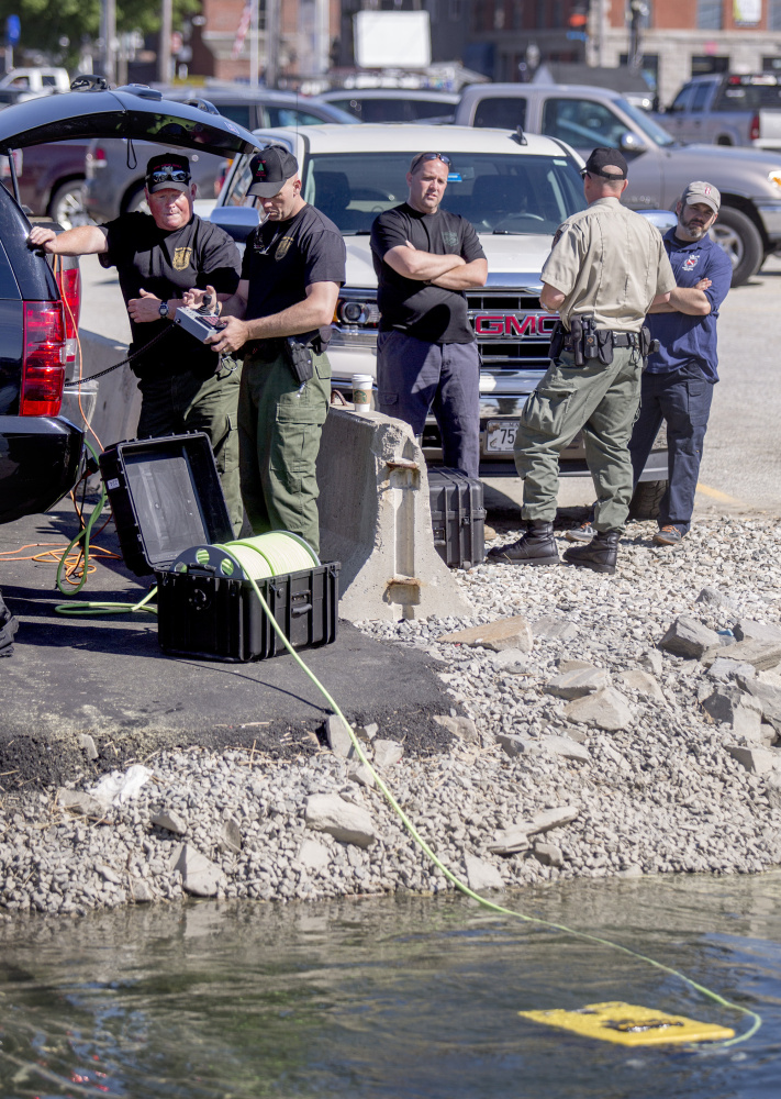 Police and Maine game wardens search the water off Chandlers Wharf for the body of Matthew Foster, 23, of Scarborough, who went missing last weekend.