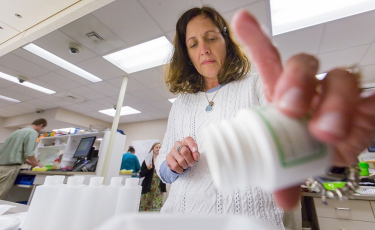 Patrice Carter, a pharmacist at Kennebec Pharmacy in Brunswick, prepares a compound that's used to treat rashes caused by browntail moth caterpillars. "I can mix the compounds in my sleep. There has been a tremendous demand," Carter said.