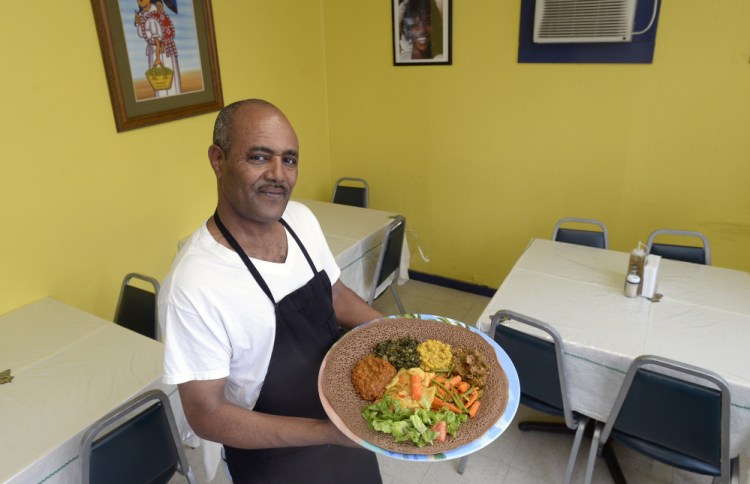 Co-owner and manager Yemane Tsegai with Red Sea's Vegetarian Sampler.