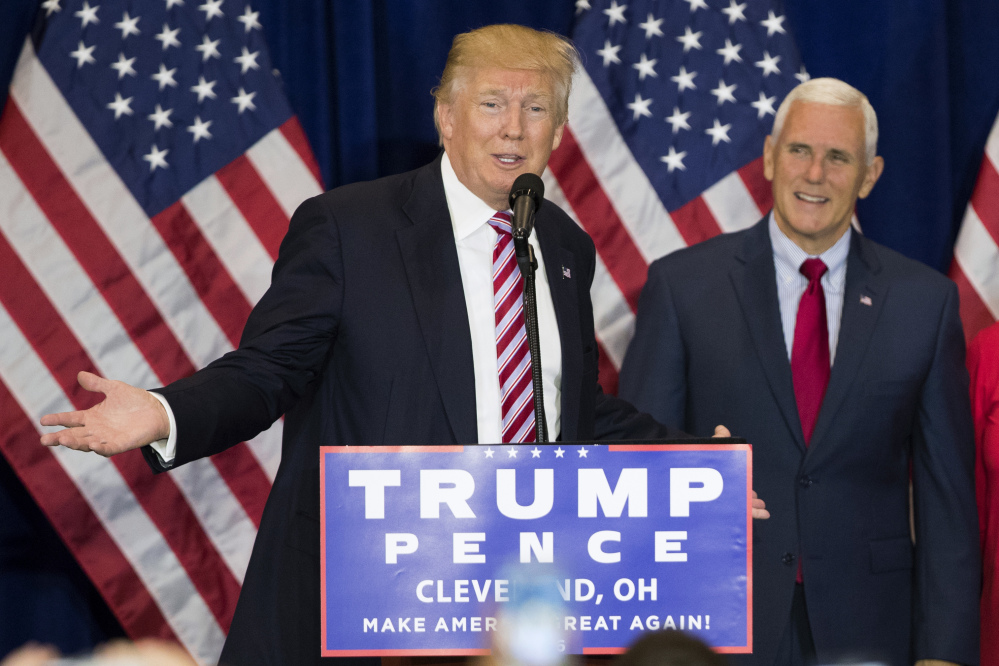 Vice presidential running mate Gov. Mike Pence, R-Ind.,  listens as Republican presidential candidate Donald Trump speaks during a goodbye reception with friends and family following the Republican National Convention on Friday in Cleveland.