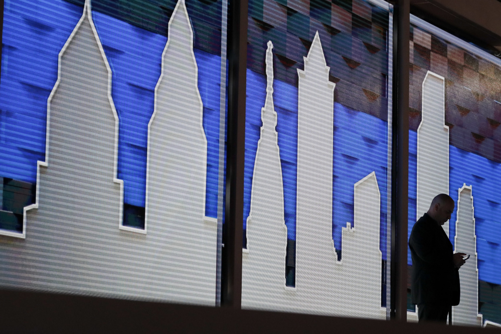 A worker looks at his phone Friday during preparations for the 2016 Democratic National Convention in Philadelphia. Beginning Monday, political heavyweights and ordinary Americans will stand up for Clinton and the Democratic ticket.