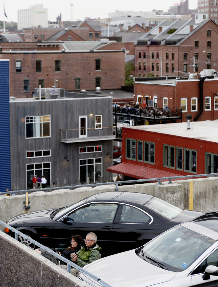 Fans take in the sounds of The Beach Boys in concert at the Maine State Pier from on top of a nearby parking garage on July 7. Music from concerts can be heard throughout downtown and as far away as Back Cove.
Shawn Patrick Ouellette/Staff Photographer