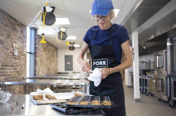 Ellie Tucker works on test batches of her Joyful Spirit granola at Fork Food Lab in Portland. Tucker also plans to market health bars.