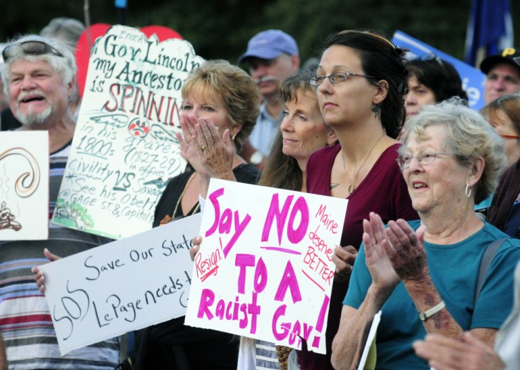 People clap during speeches during a rally on Tuesday in Capitol Park in Augusta. Many participants called for Gov. Paul LePage to resign or get help in controlling with his behavior.