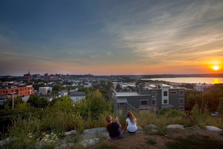 Nicole Hoglund of Portland, left, watches the sunset with her niece Sophia Lanzano on Aug. 12, 2016, from Fort Sumner Park in Portland. 