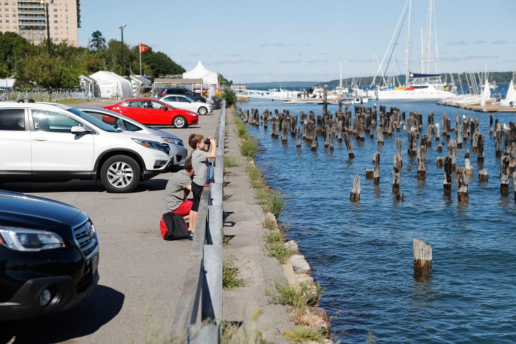 Noah Legere, 8, and his father, Jeff, look out at an osprey nest on a piling Monday at the so-called Amethyst lot on Portland's waterfront. The city is launching a year-long planning effort that would convert the lot into a waterfront park.